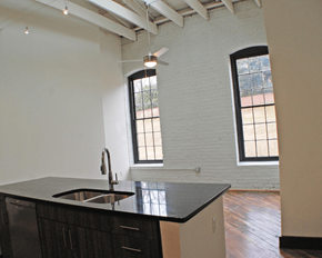 Richmond apartment for rent - A kitchen with a black counter top and a window.