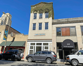 Richmond apartment for rent - A building with a green awning and a sign that says "Wellness" is in the background.