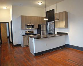 Richmond apartment for rent - A kitchen with wooden floors and white walls.