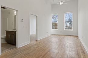 Richmond apartment for rent - Large living room space facing Broad Street in Richmond, Virginia. Warm hardwood floors and bright white walls