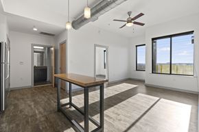 Richmond apartment for rent - A spacious room with a table and a ceiling fan.