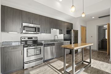 Richmond apartment for rent - A modern kitchen with stainless steel appliances and wooden accents.