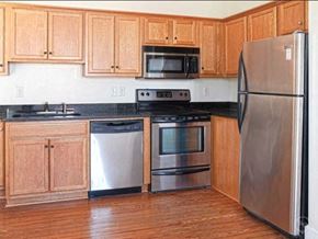 Portsmouth apartment for rent - A kitchen with wooden cabinets and stainless steel appliances.
