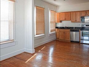 Portsmouth apartment for rent - A kitchen with wooden floors and wooden cabinets.