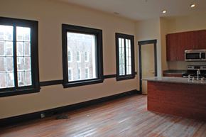 Richmond apartment for rent - A kitchen with a wooden floor and a window.