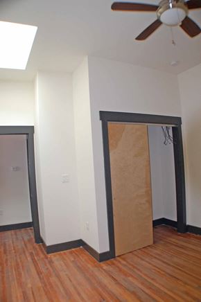 Richmond apartment for rent - A room with a ceiling fan and a doorway covered in cardboard.