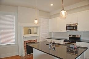 Richmond apartment for rent - A kitchen with a black counter top and white cabinets.