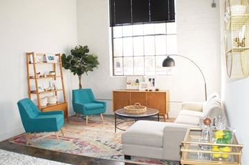 Norfolk apartment for rent - A living room with a blue chair and a wooden cabinet.
