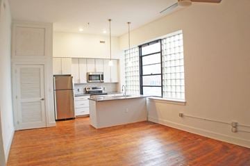 Richmond apartment for rent - A kitchen with a refrigerator, microwave, and oven.