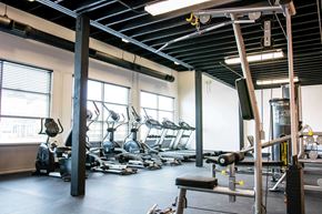 Norfolk apartment for rent - A gym with a variety of equipment including treadmills, weights, and exercise machines.
