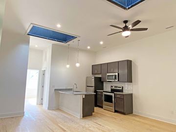Richmond apartment for rent - A kitchen with a ceiling fan and a microwave oven.