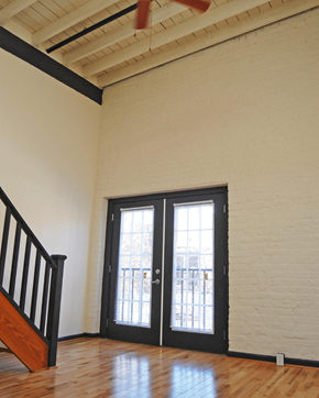 Richmond apartment for rent - A room with a staircase and a door with a window.