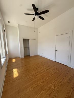 Richmond apartment for rent - A room with a ceiling fan and wooden flooring.