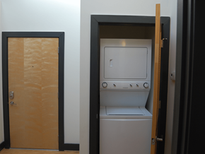 Suffolk apartment for rent - A small white washing machine is in a doorway.