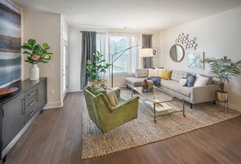 A living room with a green chair and a white couch.
