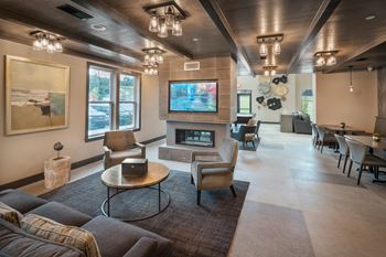 A modern living room with a large flat screen tv mounted on the wall.