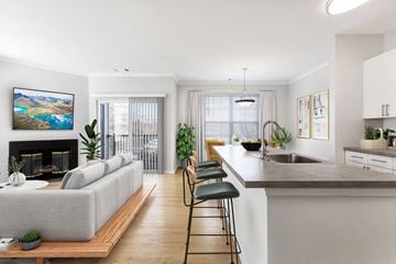 Lawrence Township apartment for rent - A modern living room with a grey sofa and a fireplace.