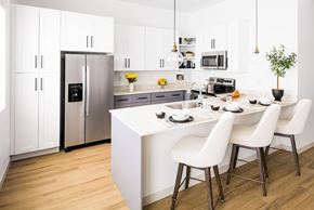 Glendale apartment for rent - a kitchen with white cabinets and a white island with white chairs at Onyx at Westgate Apartments, Glendale, 85305