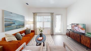 Bradenton apartment for rent - A living room with a couch, a coffee table, and a painting on the wall.