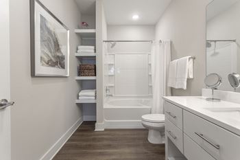 A bathroom with a shower and a toilet and a sink