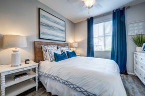 Litchfield Park apartment for rent - A bedroom with a large bed and a painting on the wall.
