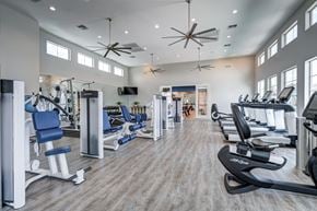 Litchfield Park apartment for rent - A spacious gym with a variety of equipment and a ceiling fan.