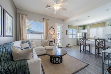Surprise apartment for rent - A living room with a white couch and a coffee table.