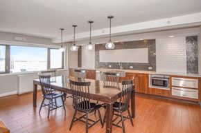 Long Beach apartment for rent - a club house with a table and chairs and a kitchen at 10 West Apartments, New York 11561