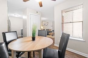 Oklahoma City apartment for rent - a dining room with a wooden table and black leather chairs at Diamond  Trail Apartments, Oklahoma