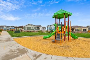 Brighton apartment for rent - a playground with yellow mulch and houses in the background at The Villas at Prairie Center, Brighton