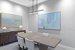 Ashland apartment for rent - a dining room with a wooden table and white chairs and two paintings on the wall at Cirrus Apartments, Massachusetts