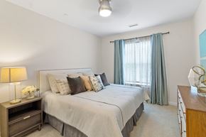 Ashland apartment for rent - a bedroom with a bed and a dresser with a lamp at Cirrus Apartments, Ashland, Massachusetts