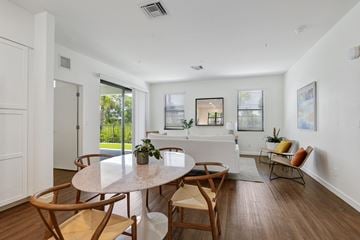 Fort Myers apartment for rent - a living room with a white couch and a table and chairs