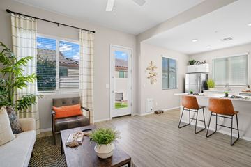 Goodyear apartment for rent - A living room with a brown leather chair and a white couch.