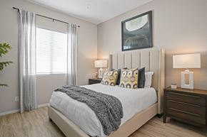 Goodyear apartment for rent - an overview of a bedroom with a bed and a window at Soleil at Canyon Trails Apartments, Arizona