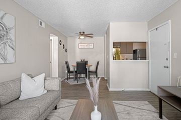Oklahoma City apartment for rent - a living room and dining room with a couch and a table