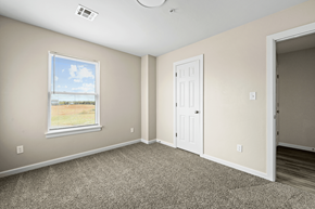 Oklahoma City townhouse for rent - an empty bedroom with a door and a window at Diamond Ridge Townhomes, Oklahoma City, OK