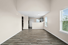 Oklahoma City townhouse for rent - an empty living room and kitchen with wood flooring and a window at Diamond Ridge Townhomes, Oklahoma City, 73114
