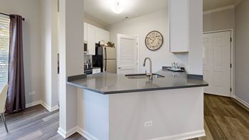 A kitchen with a large counter top and a sink