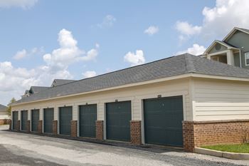 Private garages with green garage doors