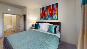 Winter Springs apartment for rent - a bedroom with a large bed and a colorful painting on the wall at Integra 360 Apartments, Florida, 32708