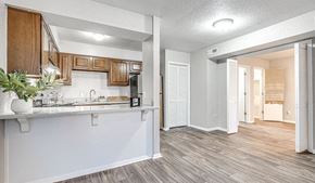 Oklahoma City apartment for rent - an open kitchen and living room with a door to a hallway at Diamond Ridge Apartments, Oklahoma City