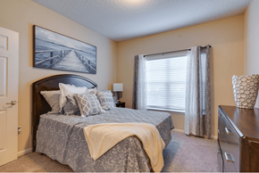 Jacksonville apartment for rent - a bedroom with a bed and a dresser at Magnolia Village Apartments, Florida