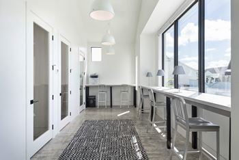 A kitchen with a long counter and a large window