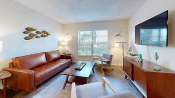 Largo apartment for rent - A living room with a brown leather couch and a wooden coffee table.