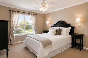 Chattanooga apartment for rent - A bedroom with a large bed and a window with curtains.