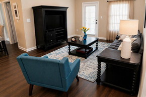 Chattanooga apartment for rent - A living room with a blue chair and a black cabinet.