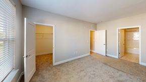 Hazlet apartment for rent - a bedroom with a closet and a door to a bathroom at The Landing Apartments, Hazlet, 07730