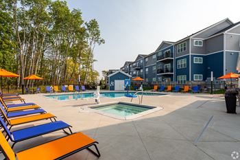 Large pool with lounge chairs and umbrellas