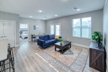 Grand Rapids apartment for rent - an open living room and dining room with a couch and a coffee table